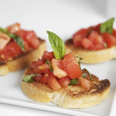 Italian Bruschetta appetizer on a white porcelain plate.